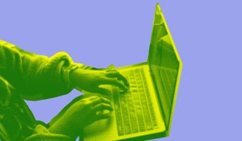 An image of hands typing on a laptop computer